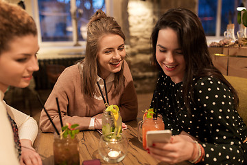 Image showing happy friends with drinks at restaurant