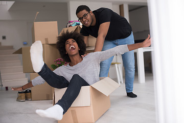 Image showing African American couple  playing with packing material