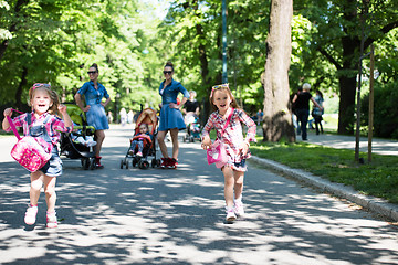 Image showing twins mother with children  in city park