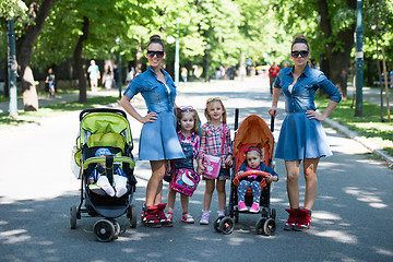 Image showing twins mother with children  in city park