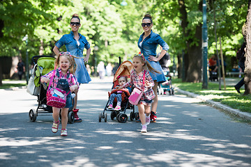 Image showing twins mother with children  in city park