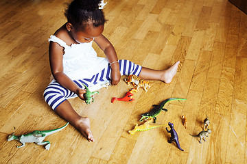 Image showing little cute african american girl playing with animal toys at ho