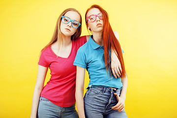 Image showing lifestyle people concept: two pretty school girl having fun on yellow background, happy smiling students 