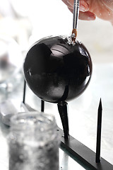 Image showing Christmas decorations. A self painted Christmas balls Black bauble Christmas tree 