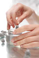 Image showing Silver Christmas decorations. Woman decorating Christmas star