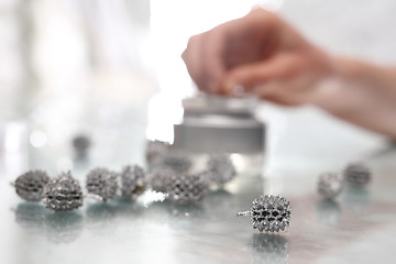 Image showing Woman decorate baubles. Christmas tree decorations