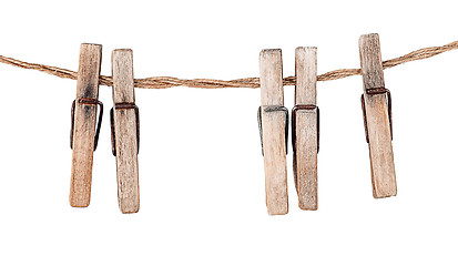 Image showing Five old clothespins on rope