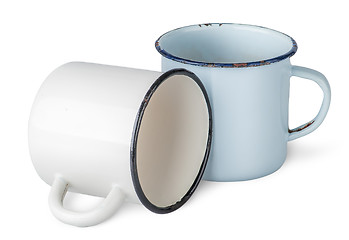 Image showing Two old enameled mugs beside