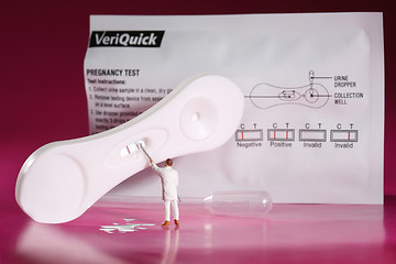 Image showing Funny Miniature Health Worker Painting Over Pregnancy Test Resut