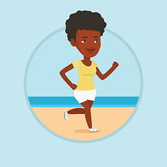 Image showing Young sporty woman jogging on the beach.