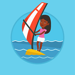 Image showing Young woman windsurfing in the sea.