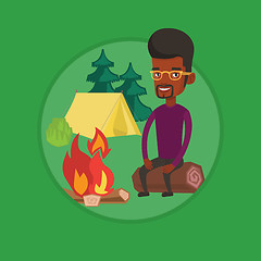 Image showing Man sitting on log near campfire in the camping.