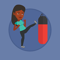 Image showing Woman exercising with punching bag.