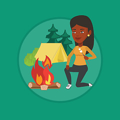 Image showing Woman roasting marshmallow over campfire.