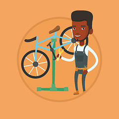 Image showing African bicycle mechanic working in repair shop.