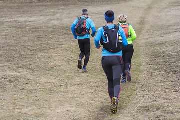 Image showing Two women and a man jogging and running outdoors in nature