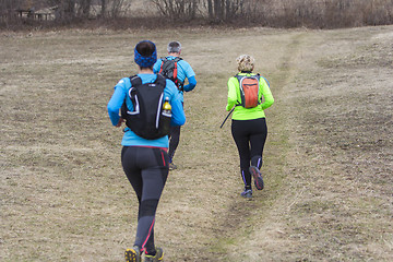 Image showing Two women and a man jogging and running outdoors in nature