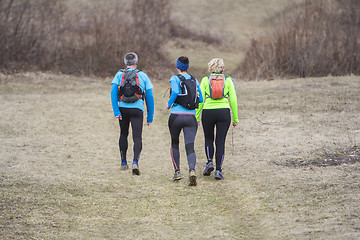 Image showing Two women and a man jogging and running outdoors in nature