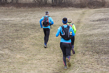 Image showing Two women and a man jogging and running outdoors in nature