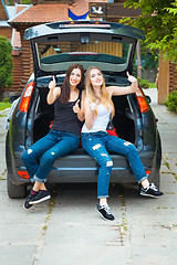 Image showing Two girls posing in car