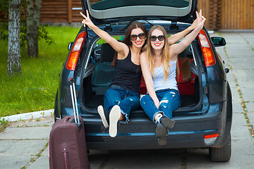 Image showing Two girls posing in car