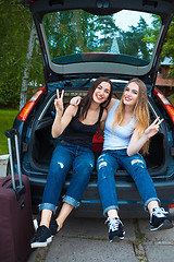 Image showing Two girls posing in car