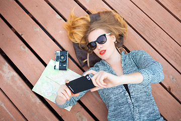 Image showing Woman with cellphone taking photo