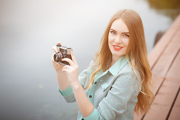 Image showing Pretty young woman traveling with photo camera and making pictures