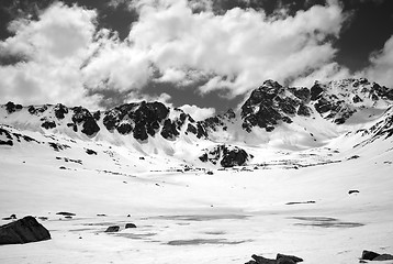 Image showing Black and white view on frozen mountain lake covered with snow