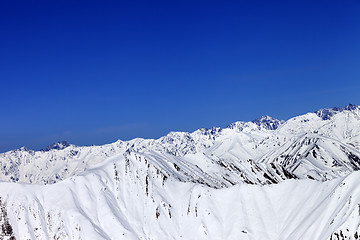 Image showing Winter snow mountains and blue clear sky
