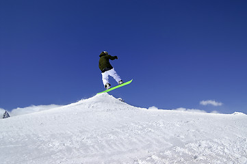 Image showing Snowboarder jump in snow park at ski resort on sun winter day