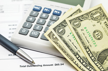 Image showing Table with money, calculator and pen