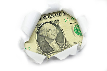 Image showing US currency peeking through white paper.