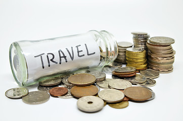 Image showing Travel lable in a glass jar with coins spilling out