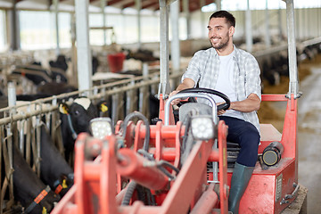 Image showing man or farmer driving tractor at farm