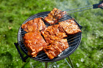 Image showing meat cooking on barbecue grill at summer party