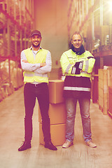 Image showing men in uniform with boxes at warehouse