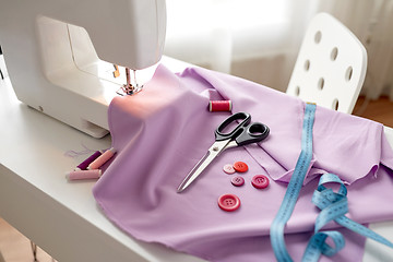 Image showing sewing machine, scissors, buttons and fabric