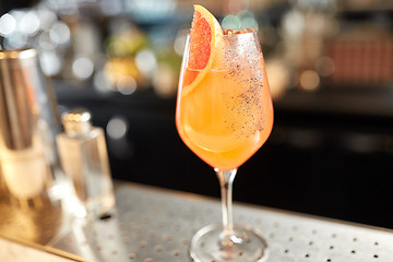 Image showing glass of grapefruit cocktail at bar