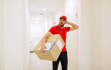 Image showing delivery man with box and clipboard in corridor