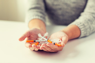 Image showing close up of woman hands holding insulin syringes