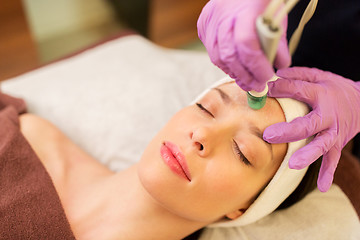 Image showing woman having microdermabrasion facial treatment