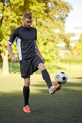 Image showing soccer player playing with ball on field