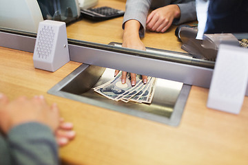 Image showing clerk giving cash money to customer at bank office