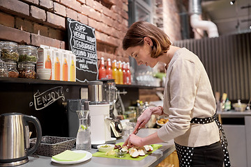 Image showing happy woman or barmaid cooking at vegan cafe