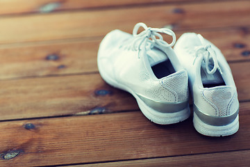 Image showing close up of sneakers on wooden floor