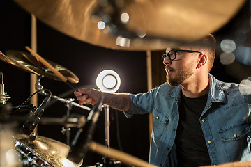 Image showing male musician playing drums and cymbals at concert