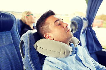 Image showing man sleeping in travel bus with cervical pillow