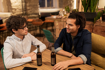 Image showing happy male friends drinking beer at bar or pub