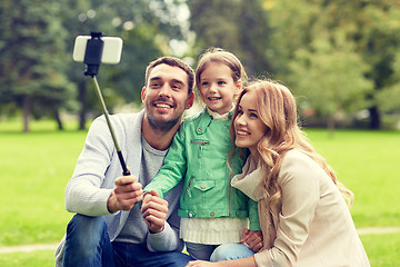 Image showing happy family taking selfie by smartphone outdoors